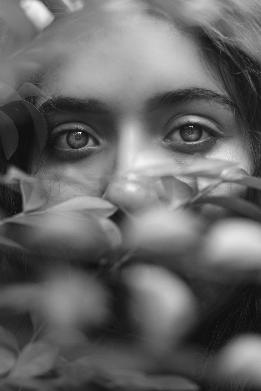 monochrome photo of girl s eyes