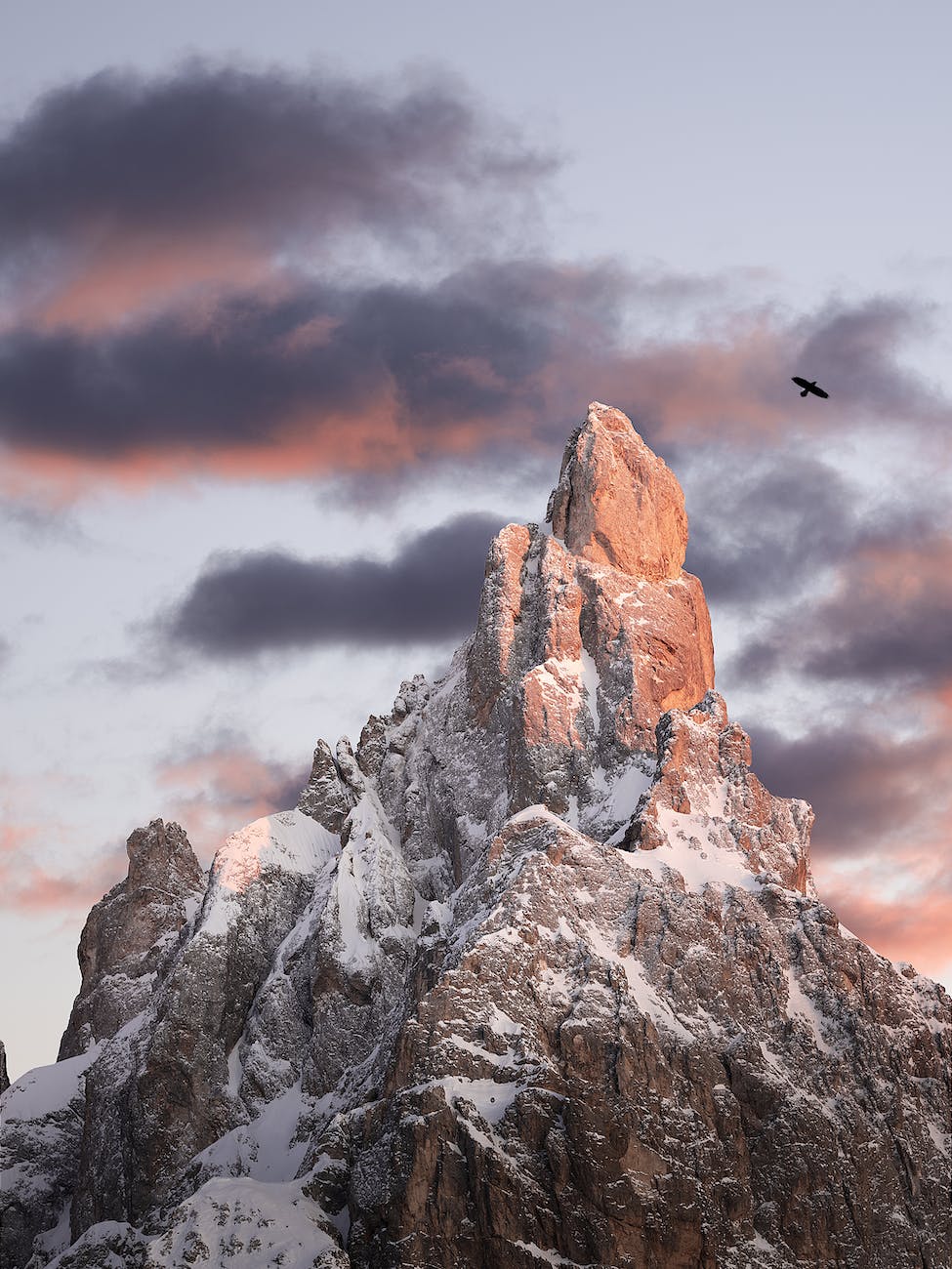 close up shot of a snow covered rocky mountain during sunset